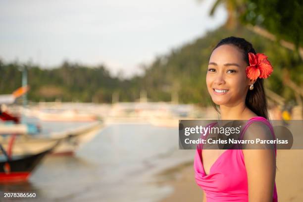 pretty filipino woman at the beach, smiling and looking at the camera. - argentina beach stock pictures, royalty-free photos & images