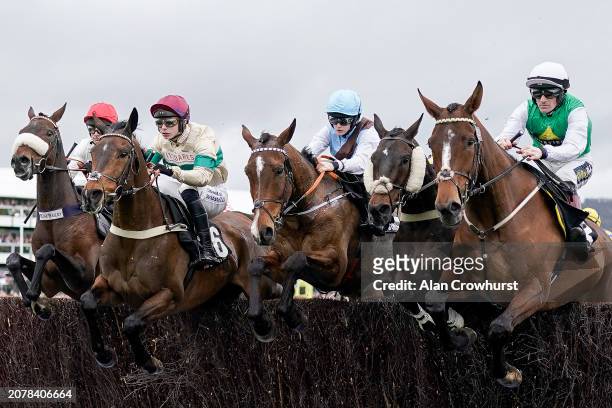 General view as runners clear a fence during The Ultima Handicap Chase during day one of the Cheltenham Festival 2024 at Cheltenham Racecourse on...