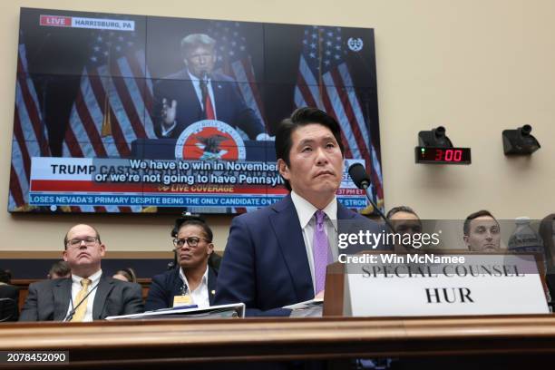 Former special counsel Robert K. Hur testifies in front of a video of former President Donald Trump during a hearing held by the House Judiciary...