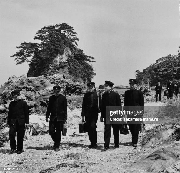 Crown Prince Akihito of Japan during an outing with school friends, all wearing the Peers' School uniform, at Joga-shima island in Japan, 1950. Two...