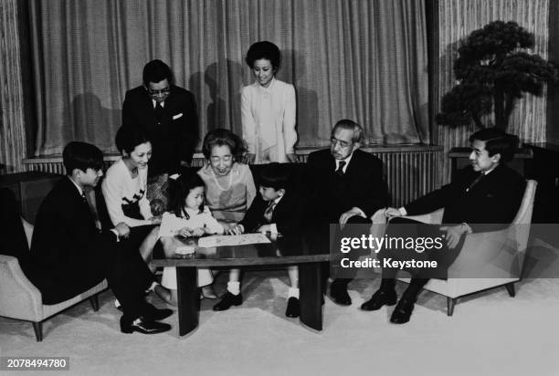 Emperor Hirohito and his family are seen during their photo session ahead of the New Year at the Imperial Palace in Tokyo, December 20th 1974. Left...