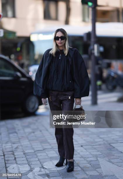 Fashion Week Guest seen wearing a black puffer jacket, brown leather pants, black leather shoes, black sunglasses and a black Stella McCartney bag...