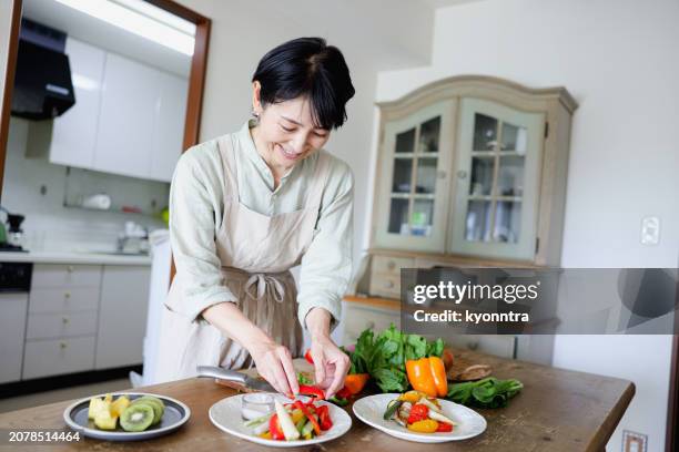 woman making vegan food - immune system stock pictures, royalty-free photos & images