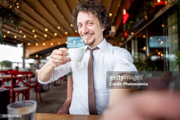man with necktie taking selfie at cafeteria - entrepreneur stock pictures, royalty-free photos & images