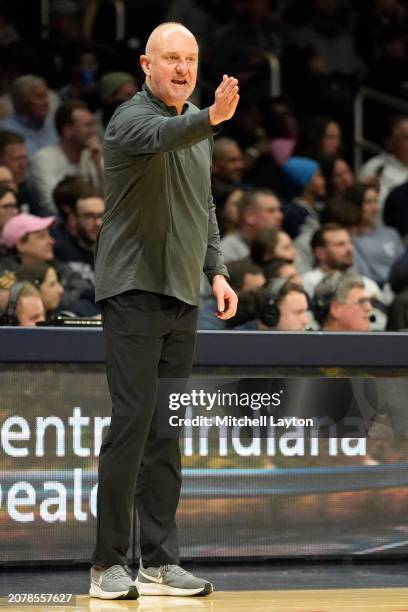 Head coach Thad Matta of the Butler Bulldogs signals to his players during a college basketball game against the Xavier Musketeers at Hinkle...