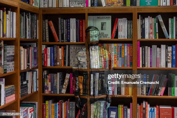 Chinese artist Liu Bolin performs at Libreria Hoepli on March 12, 2024 in Milan, Italy. Represented in Italy by Galleria Gaburro, Liu Bolin has been...