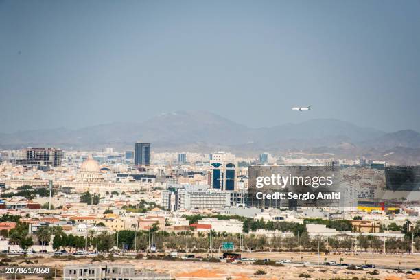plane landing over jeddah skyline - jeddah architecture stock pictures, royalty-free photos & images