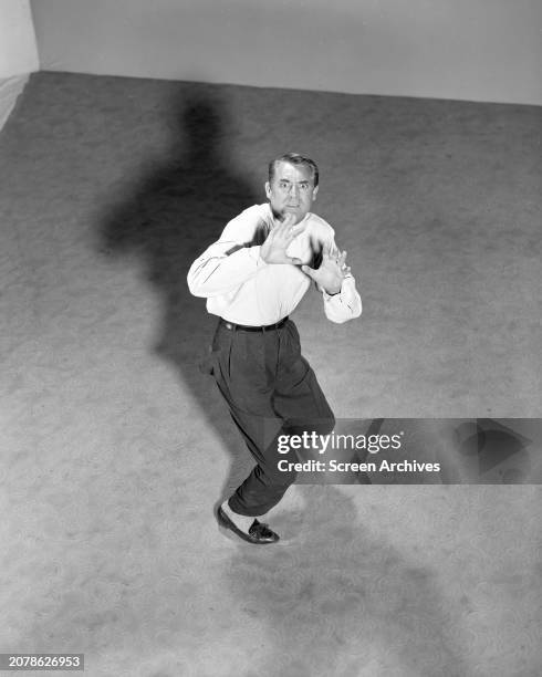 Cary Grant posing for publicity shot for the classic 1959 release of Alfred Hitchcock's 'North By Northwest'.