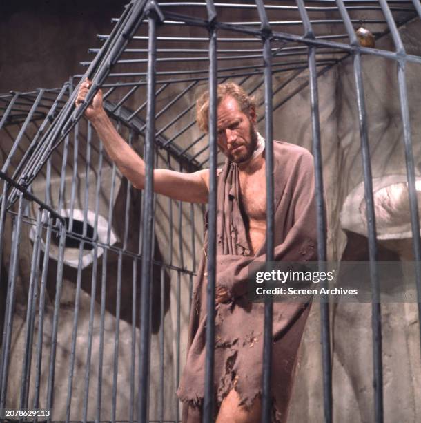 Charlton Heston in cage in a scene from the 1968 version of 'Planet of the Apes'.