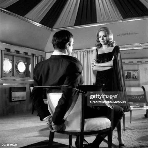 Karin Dor facing Sean Connery as James Bond 007 who is tied to chair in a scene from the 1967 movie 'You Only Live Twice'.