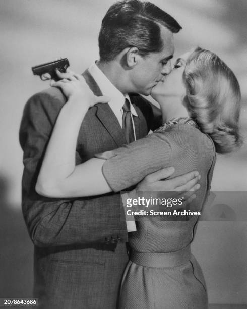 North by Northwest' Cary Grant kissing Eva Marie Saint as she holds un behind his back in a publicity pose for the 1959 MGM film directed by Alfred...