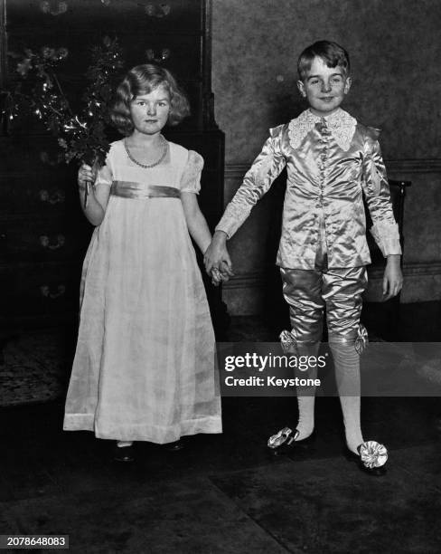 Diana Bulteel, a sprig of holly in her right hand, her left hand holding the hand of Seymour Egerton, Earl of Wilton, in preparation for a Christmas...