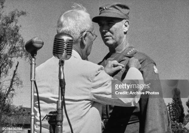 South Korean politician Syngman Rhee, President of South Korea, decorating American military officer James Van Fleet, US Army General,AT a ceremony...