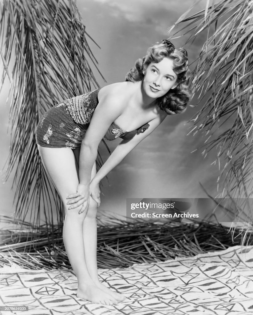 Vera Miles poses barefoot in swimsuit for publicity portrait, circa