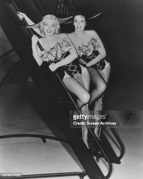 Marilyn Monroe and Jane Russell pose in showgirl costumes for the 1953 film 'Gentlemen Prefer Blondes'.