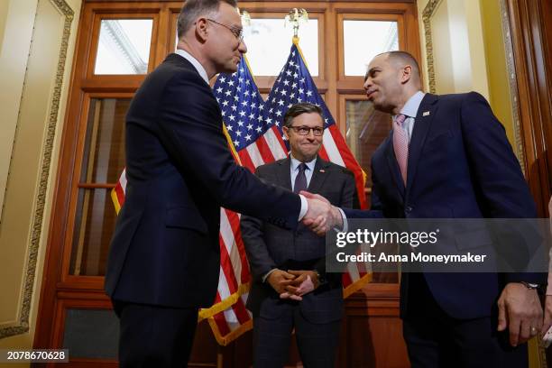 Speaker of the House Mike Johnson looks on as House Minority Leader Hakeem Jeffries greets Polish President Andrzej Duda at the U.S. Capitol on March...