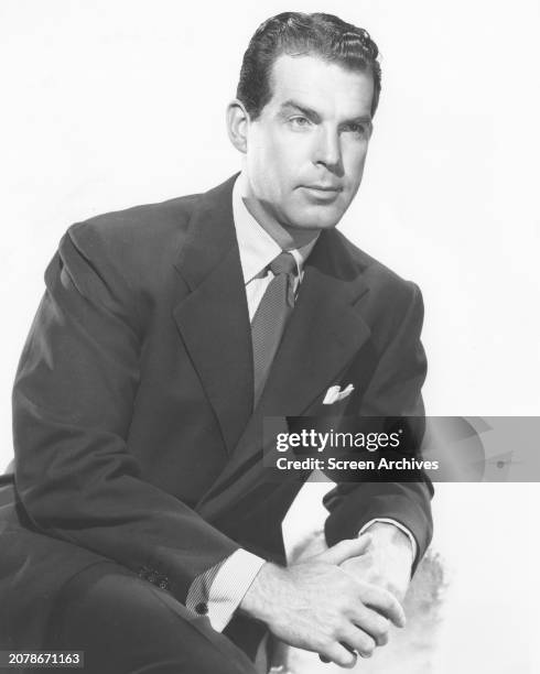 Fred MacMurray wearing suit in a studio portrait circa 1944.