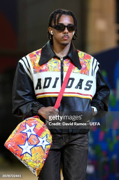 Jules Kounde of FC Barcelona arrives at the stadium wearing a collection of clothes and accessories fashioned from the UEFA Champions League official...