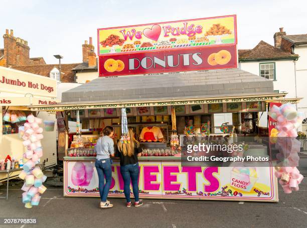 Mops fair fairground, High Street, Marlbrough, Wiltshire, England, UK October 7th 2023 - Donuts and Sweets stall.