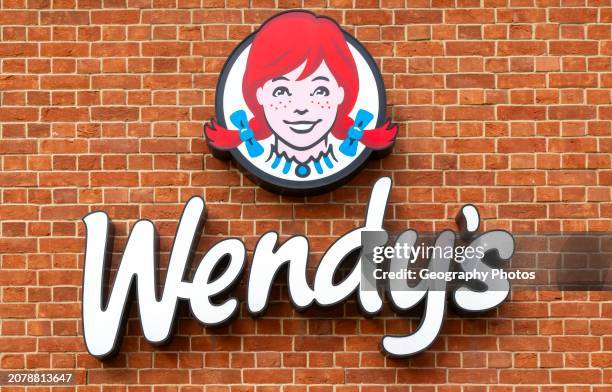 Logo and sign Wendy's fast-food restaurant, Reading, Berkshire, England, UK.