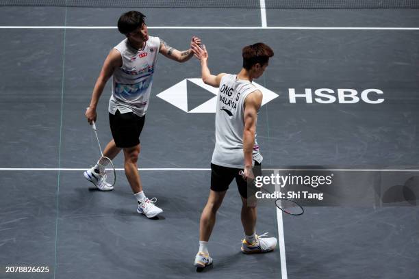Ong Yew Sin and Teo Ee Yi of Malaysia react in the Men's Doubles first Round match against Liu Yuchen and Ou Xuanyi of China during day one of the...