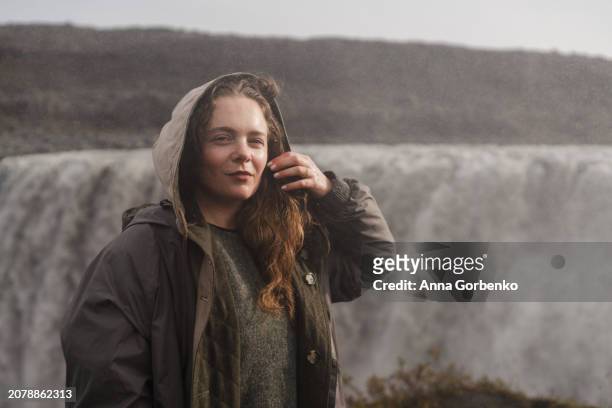 traveling and exploring iceland landscapes and travel destinations. female tourist watching spectacular scenery outdoors. dettifoss waterfall. - dettifoss waterfall stock pictures, royalty-free photos & images