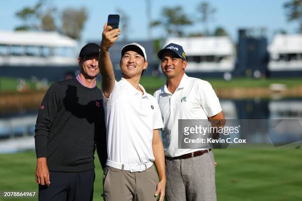 Min Woo Lee of Australia takes a selfie with Adam Scott of Australia and Jason Day of Australia on the 17th tee prior to THE PLAYERS Championship on...
