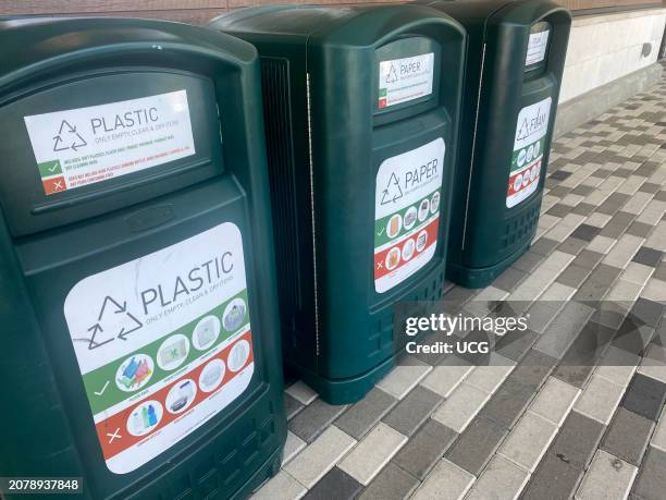 Three recycling bins outside shopping mall, illustrating what items are and are not recyclable, Plastic, Paper and Foam, Florida.