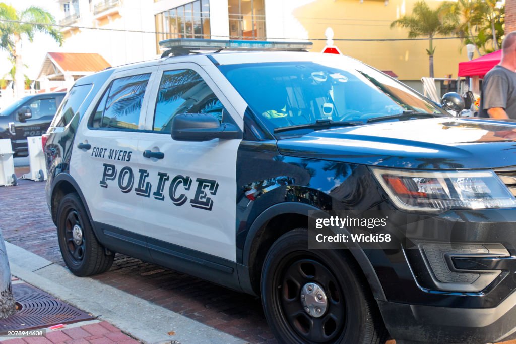 Police cars secure the streets of downtown Fort Myers for a festival
