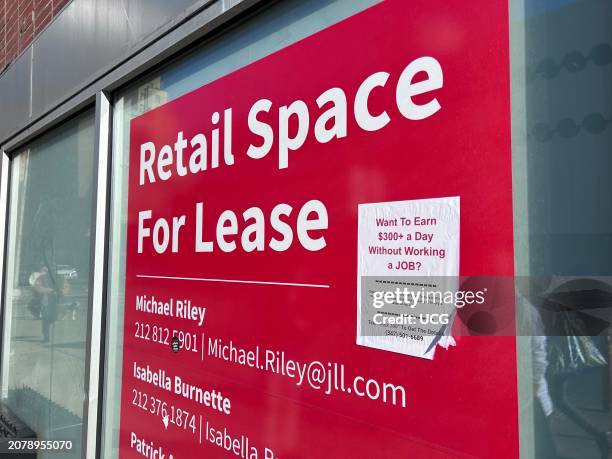 Retail space for lease sign with poster about earning $300 a day without a job, Manhattan, New York.