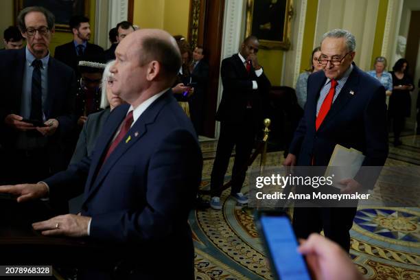 Senate Majority Leader Chuck Schumer listens as Sen. Chris Coons speaks to reporters after the weekly Senate Democrats caucus policy luncheon at the...