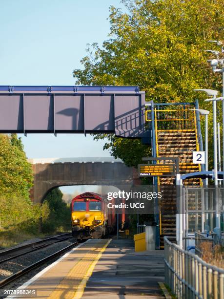 Bridges over the tracks at Radley Railway Station , freight train passing through.