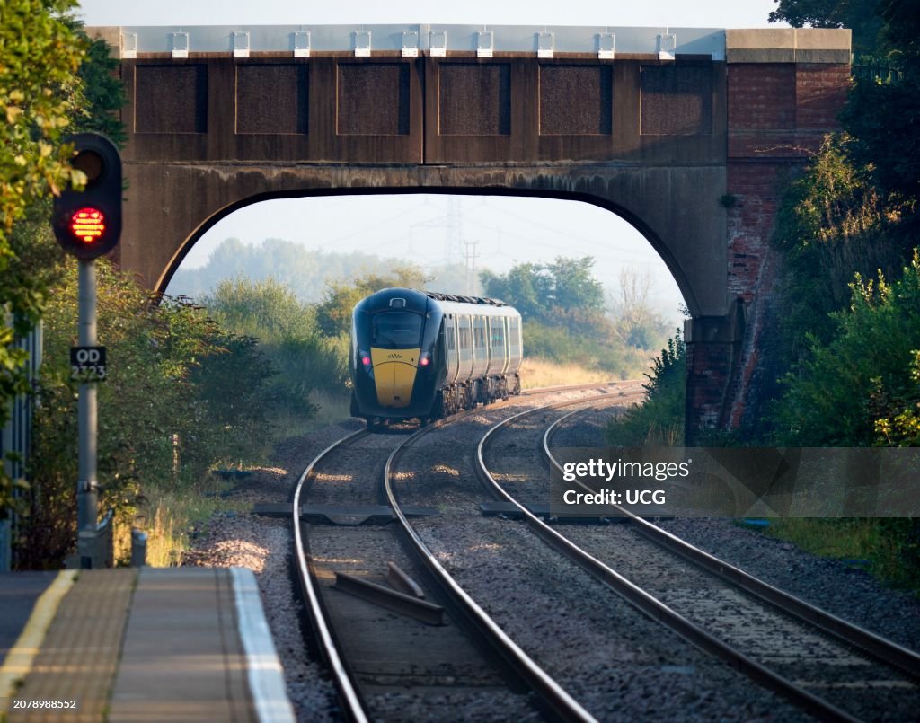Bridges over the tracks at Radley Railway Station, commuter train passing through