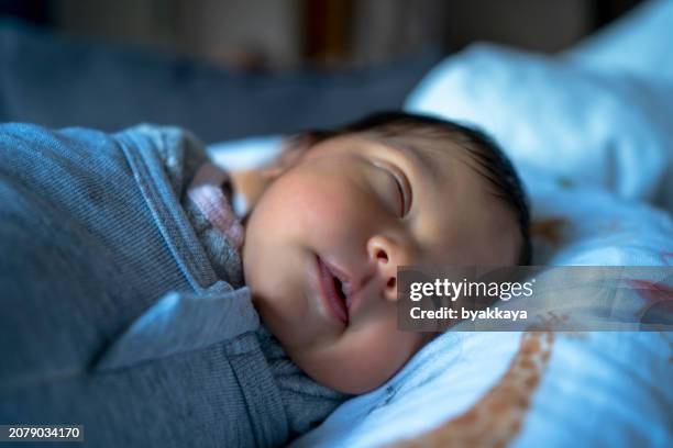 a newborn baby sleeping swaddle - sleeping baby blanket stock pictures, royalty-free photos & images