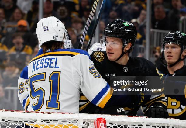Matthew Kessel of the St. Louis Blues gets tangled-up with Trent Frederic of the Boston Bruins during the first period at the TD Garden on March 11,...