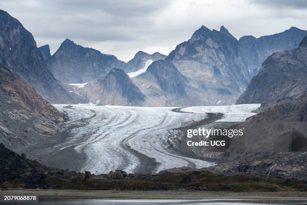 Glacier and moraines flowing into a fjord, Prince Christian Sound, Greenland.