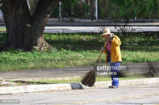 Santa Clara, Cuba, A senior person works as a street sweeper.