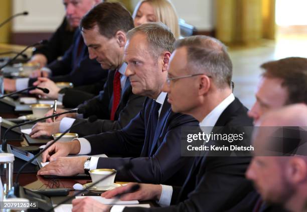 Prime Minister of Poland Donald Tusk , seated next to Polish President Andrzej Duda , participates in a meeting with U.S. President Joe Biden in the...