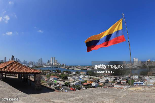 Cartagena, Colombia, A Colombian flag is seen from the San Felipe castle, with the city of Cartagena in the background.