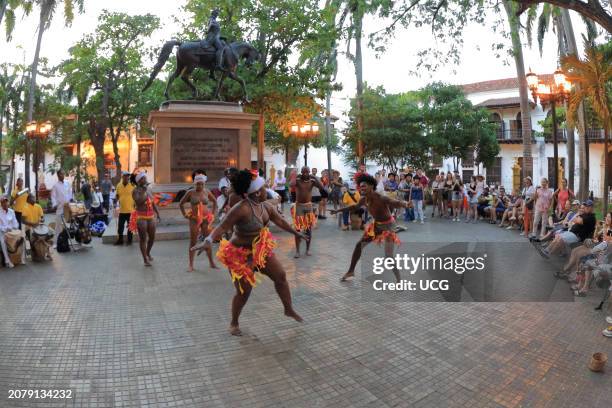 Cartagena, Colombia, The Mapale dance performed by natives of Cartagena is watched by tourist in the Plaza Bolivar of the walled city.