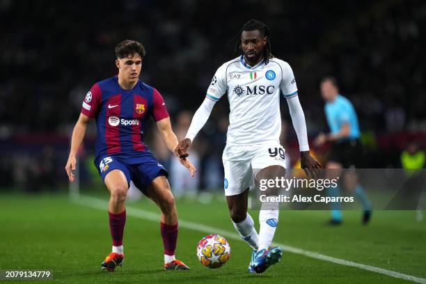 Andre-Frank Zambo Anguissa of SSC Napoli passes the ball whilst under pressure from Pau Cubarsi of FC Barcelona during the UEFA Champions League...