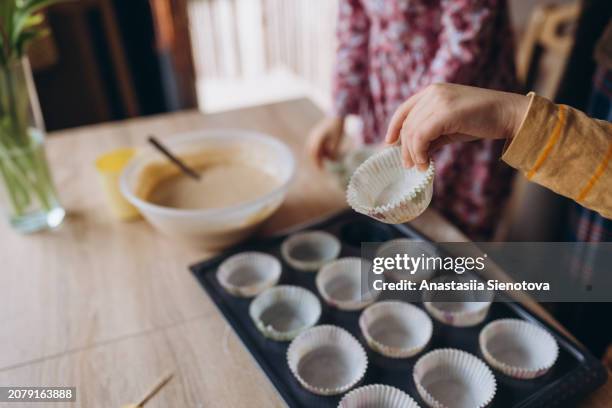 children's hands preparing muffins - muffin tin stock pictures, royalty-free photos & images