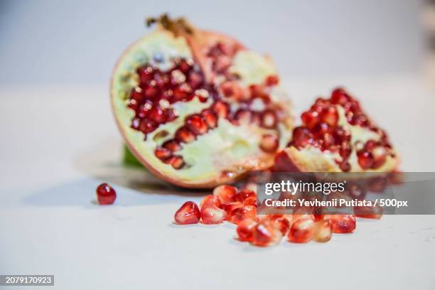 close-up of pomegranate on table - stone crop plant stock pictures, royalty-free photos & images