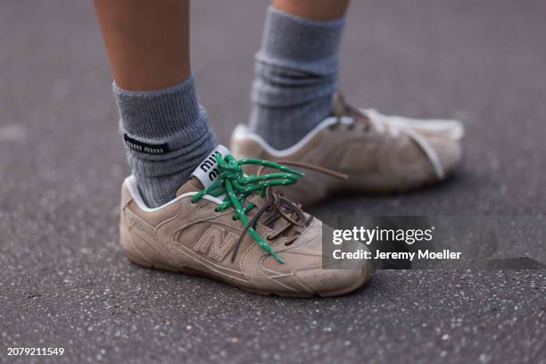 Guest seen wearing Miu Miu x New Balance beige sneaker and Miu Miu grey wool socks outside Miu Miu Show during the Womenswear Fall/Winter 2024/2025...