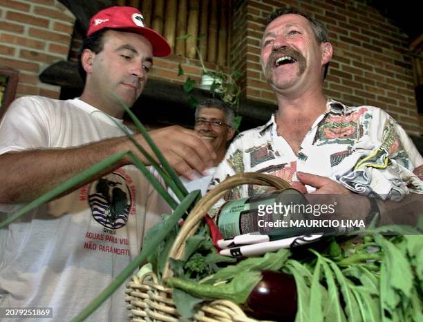 Jose Bove , French farmer leader and antiglobalization activist, receives a basket of food from a member of the Country Workers Without a Land...