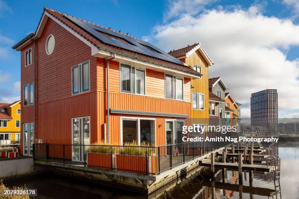 colored houses floating on water - amsterdam sunrise stock pictures, royalty-free photos & images