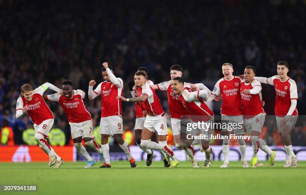 The players of Arsenal celebrate as David Raya of Arsenal makes the match-winning save from the fourth penalty from Galeno of FC Porto in the penalty...