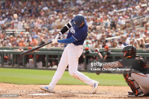 Shohei Ohtani of the Los Angeles Dodgers bats against the San Francisco Giants during the fifth inning of the MLB spring game at Camelback Ranch on...