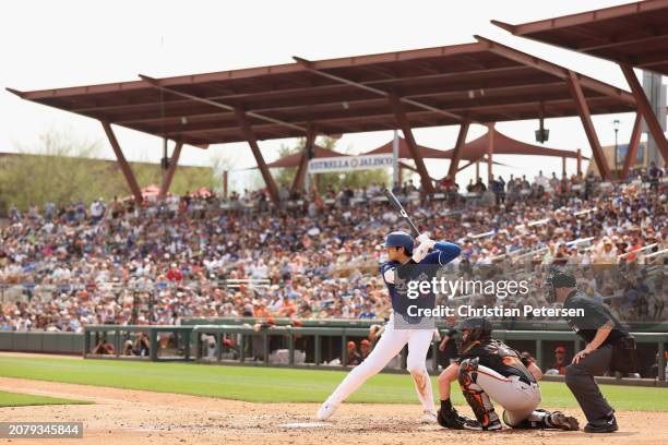 Shohei Ohtani of the Los Angeles Dodgers bats against the San Francisco Giants during the fifth inning of the MLB spring game at Camelback Ranch on...