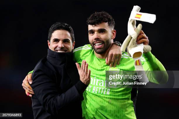 Mikel Arteta, Manager of Arsenal, and David Raya of Arsenal embrace at full-time after victory in the penalty shoot out following the UEFA Champions...